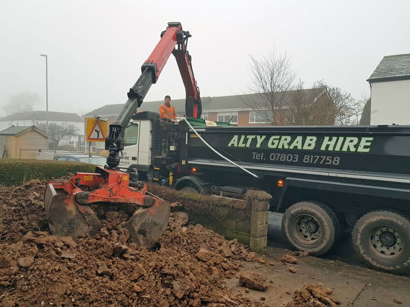 Removing clay waste from a site.